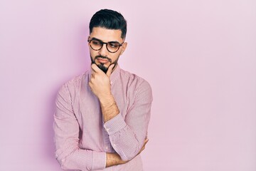 Handsome man with beard wearing casual shirt and glasses thinking looking tired and bored with depression problems with crossed arms.