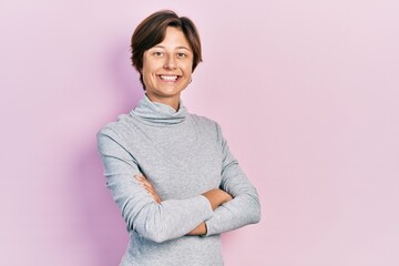 Young caucasian woman with short hair wearing casual turtleneck sweater smiling happy standing over isolated background