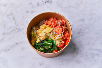  Delicious take away poke bowl on a marble surface