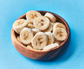  Bowl of slices of banana on a blue background
