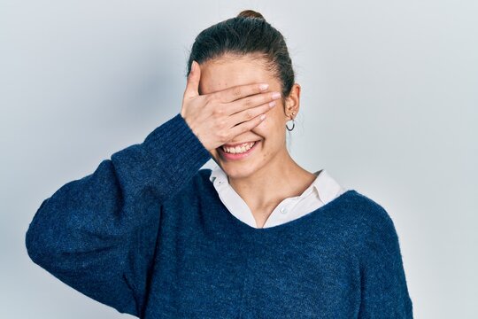 Young caucasian girl wearing casual clothes smiling and laughing with hand on face covering eyes for surprise. blind concept.