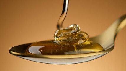 Honey dripping in golden spoon, close up. Pouring honey in spoon. Healthy organic Thick honey....