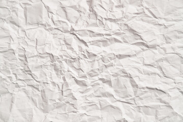 White crumpled paper texture with wrinkles. Damaged and torn sheet