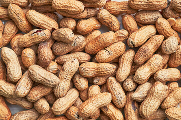 Healthy roasted unpeeled peanuts. Brown nuts texture