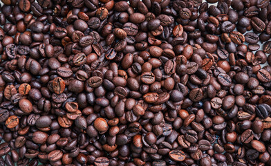 Brown and black coffee beans. Roasted arabic espresso coffee grains.