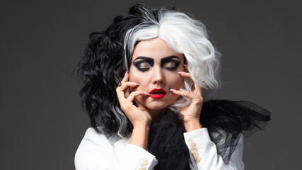 A fatal beauty in a daring fashion image with black and white hair. A rebellious stylish image for...
