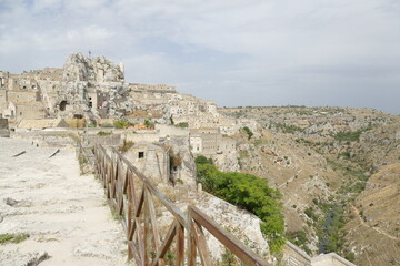 Fototapeta premium Typical stepped street between the historical buildings to Santa Maria di idris rupestrian church in Sasso Caveoso of Matera