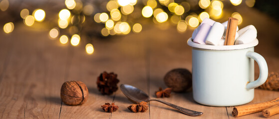 Obraz na płótnie Canvas cup of hot chocolate with marshmallows cinnamon sticks cones and branches of spruce. the concept of cozy Christmas and New Year holidays