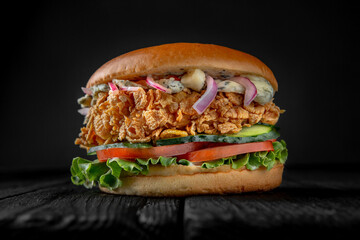 Delicious juicy burger from Brioche Bun with chicken fork or fishburger with batter in fish. Hamburger for poster or menu.