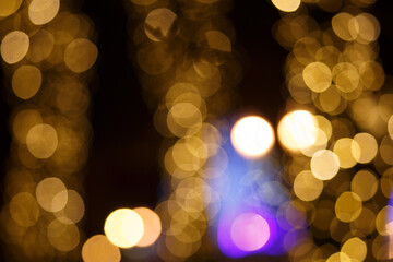 Christmas blurred background with bokeh. Unfocused background with Christmas lights. Background. Festive background with unfocused golden bokeh lights