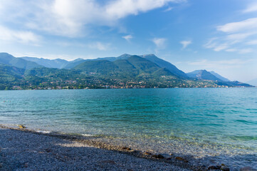 Panorama of the gorgeous Lake Garda surrounded by mountains, Italy.