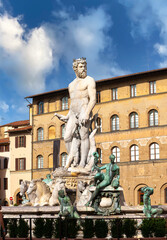 Fototapeta na wymiar Fountain of Neptune in the olt town center of Florence, Italy