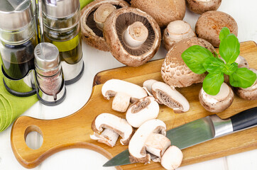 Fresh brown cultivated mushrooms champignons on wooden background. Studio Photo