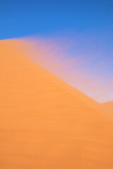 Fototapeta na wymiar Sand blowing with the wind on Dune 45, Sossusvlei, Namibia. 