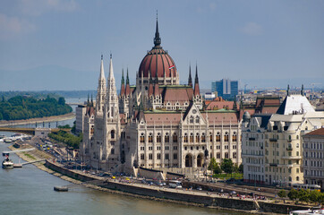 Obraz premium Hungarian Parliament building in Budapest at the daylight. Gothic architecture exterior. Tourist destination. Danube river bank