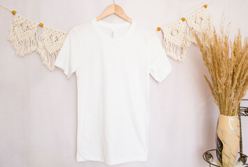 White mockup with blank t shirt with pampas grass on the boho background.
 