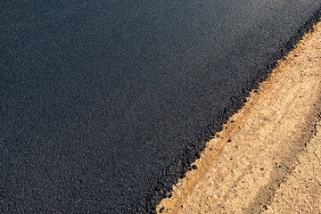 Laying of new black asphalt. Renovation of the expressway and the highway outside the city.
