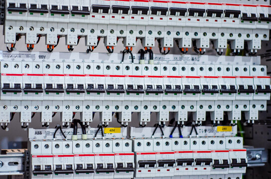 Kyiv, Ukraine - October 20, 2021: Installing ABB circuit breaker in distribution board