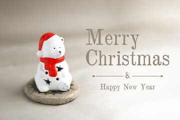 Christmas greetings card with cute white polar bear in a hat and scarf.