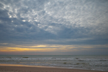 Golden hour. Sandy shore. Sunset sky.
