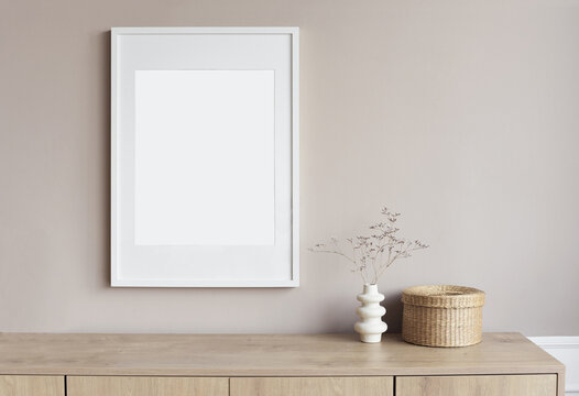 Blank picture frame mockup on gray wall. White living room design. View of modern scandinavian style interior with artwork mock up on wall. Home staging and minimalism concept
