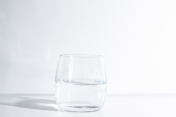 A glass of clean drinking water on a light background