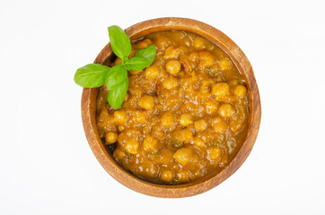 Chickpeas with curry sauce in wooden bowl. Studio Photo
