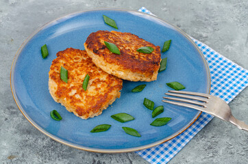 Blue plate with two minced meat cutlets. Studio Photo