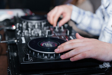DJ's hands mix music on the mixer close-up. DJ mixer, DJ mix music on the console, the DJ's hand.
