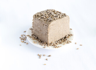 halva from sunflower seeds on a white plate. national traditional sweetness of turkish halva on the table. High quality photo