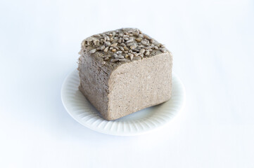 halva from sunflower seeds on a white plate. national traditional sweetness of turkish halva on the table. High quality photo