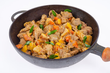 Frying pan with stew, quince and vegetables. Studio Photo