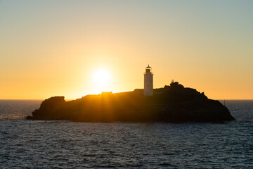 Godrevy lighthouse at sunset in Cornwall. United Kingdom
