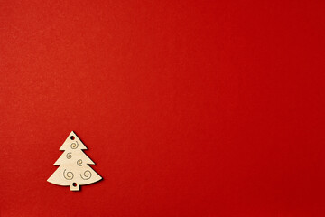 Christmas red background, with wooden Christmas trees. Minimalistic Christmas red background....