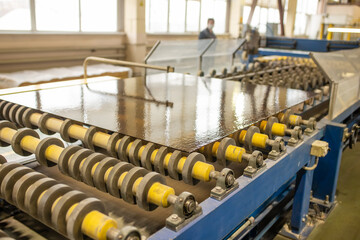 Glass conveyor line. Glass factory, industrial production of glass containers. Technological work on factory