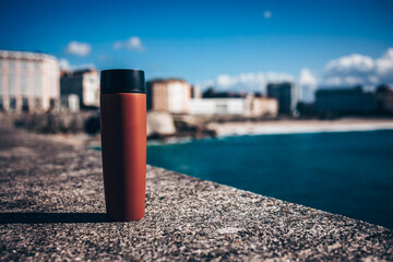 Thermos, in the background the city and the ocean
