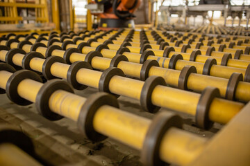 Obraz premium Glass conveyor line. Glass factory, industrial production of glass containers. Technological work on factory