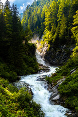 Fototapeta na wymiar Wild River With Waterfall At Umbalfaelle On Mountain Grossvenediger In Nationalpark Hohe Tauern In Tirol In Austria