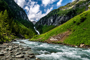 Waterfall And River Of Umbalfaelle At Mountain Grossvenediger In Nationalpark Hohe Tauern In Tirol...