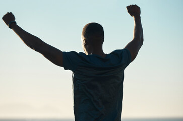 Fototapeta na wymiar Cropped photo of a man standing with his arms outstretched while exercising