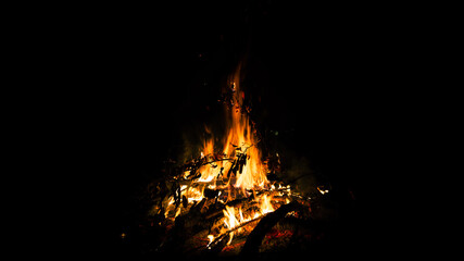 Big beautiful bonfire on black background. Real fire flames. Burning. Ignited. Night campfire....