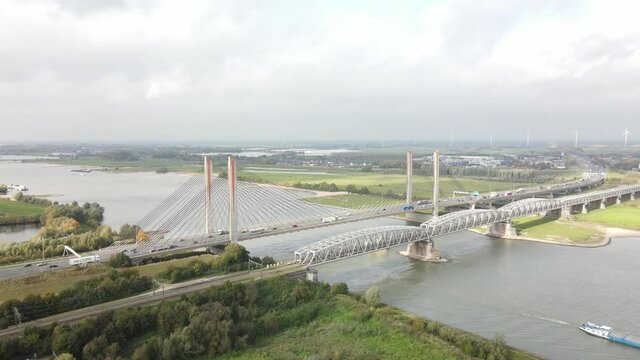 Dr. W. Hupkesbrug and Martinus Nijhoffbrug aerial drone view highway infrastructure bridge over a large waterway in The Netherlands. Zaltbommel