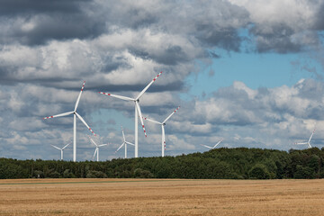 Fototapeta na wymiar Ecological wind farm. Windmills that produce electricity. Renewable energy sources.