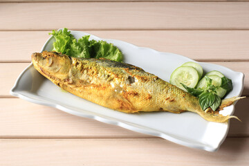 Raw Bandeng Presto Juwana, Milkfish Cooked with Pressure Cooker, Served with Chilli Paste (Sambal) and Fresh Vegetable, Copy Space for Text. Bandeng Before Deep Frying