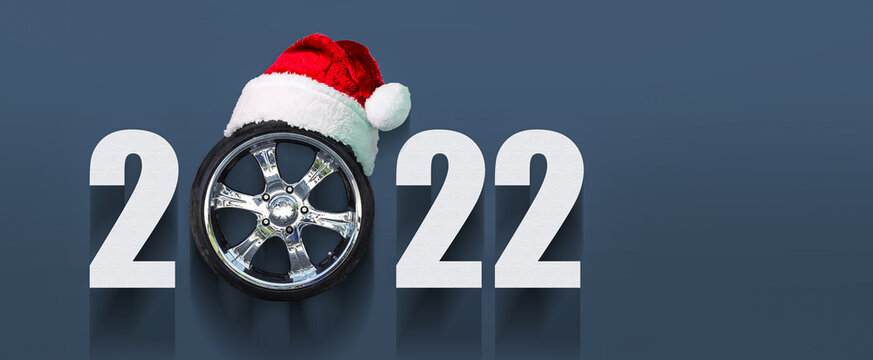 2022 Auto wheel in Santa's hat. New Year banner for auto workshop, auto shop. Copy space. Place for your text. Business.