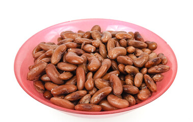 Tinned beans in red bowl on white background. Studio Photo