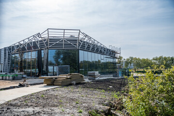 Fototapeta premium Construction in progress of a building or trade pavilion with glass walls, large windows