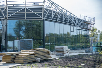 Fototapeta premium Construction in progress of a building or trade pavilion with glass walls, large windows