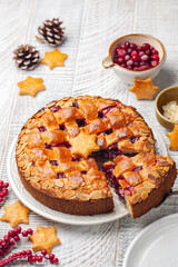 Christmas Linzer torte. Traditional Austrian cake with cranberries jam and almonds, lattice design on top. Homemade. Vertical image.