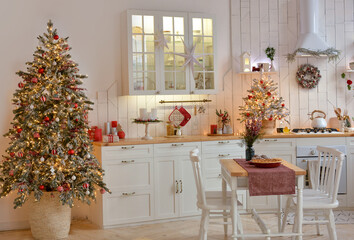 Interior of a light white ?hristmas kitchen with red decor elements in the Scandinavian style. Christmas decorations. Breakfast